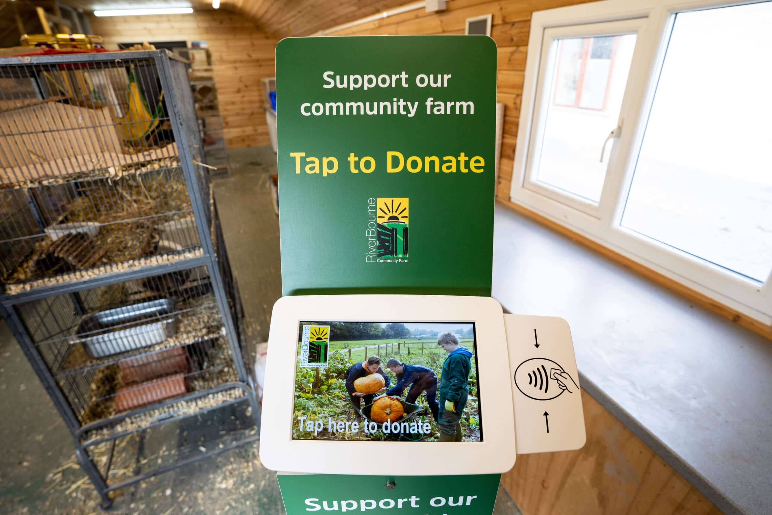 Branding on a Skinny Donation Station saying Tap to Donate