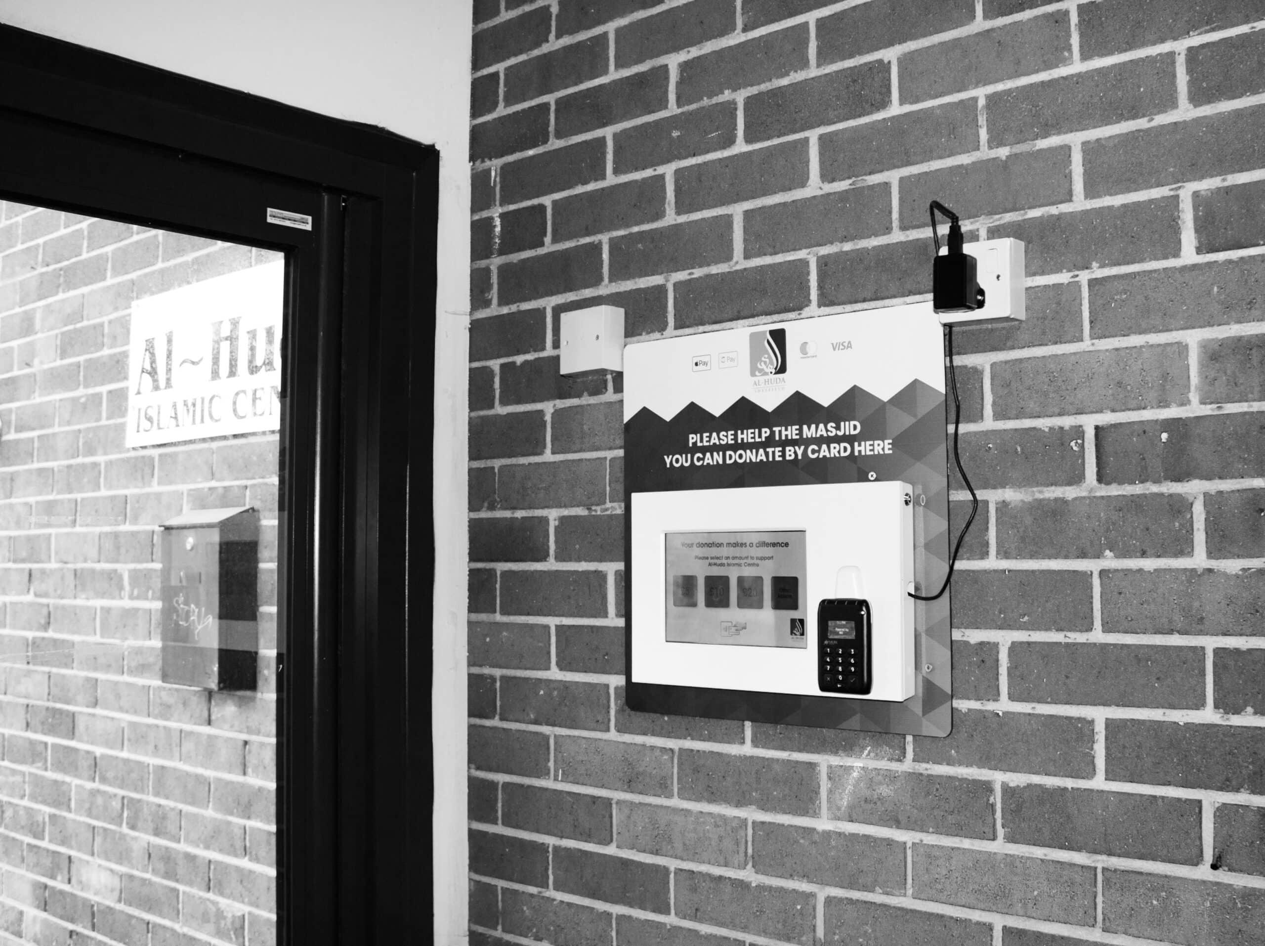 Black and White image of Donation Station inside Al Huda Centre